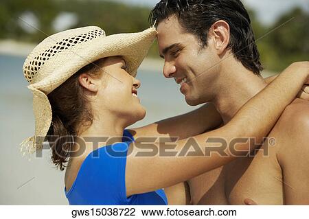 Close-up of a teenage girl embracing a young man and smiling View Large Photo Image Stock Image - Close-up of a teenage girl embracing a young man and smiling. Fotosearch