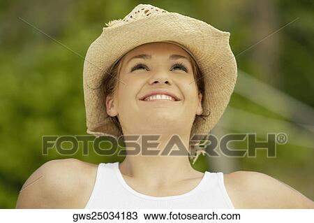 Stock Image - Close-up of a teenage girl looking up and smiling. Fotosearch