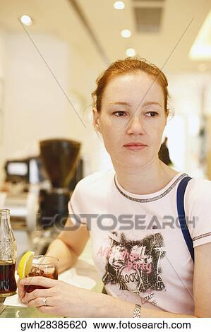 Close-up of a teenage girl sitting at a bar counter View Large Photo Image Stock Image - Close-up of a teenage girl sitting at a bar counter. Fotosearch