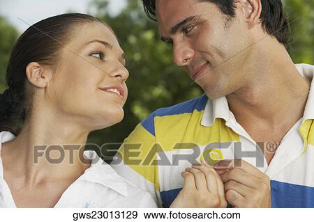 Close-up of a teenage girl with a young man holding a condom View Large Photo Image Stock Photo - Close-up of a teenage girl with a young man holding a condom. Fotosearch