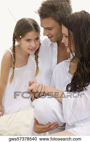 Close-up of a young couple and their daughter on the beach View Large Photo Image Stock Image - Close-up of a young couple and their daughter on the beach. Fotosearch