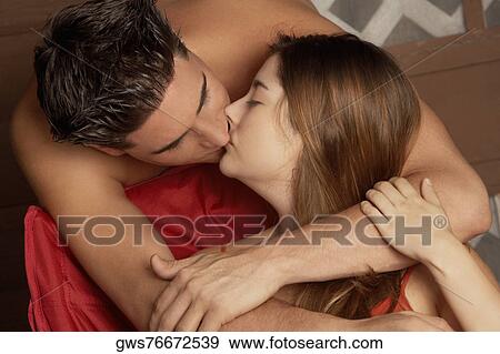 Close-up of a young couple kissing each other View Large Photo Image Stock Photo - Close-up of a young couple kissing each other. Fotosearch