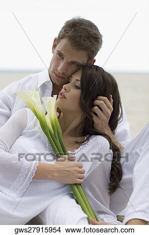 Picture - Close-up of a young couple on the beach. Fotosearch