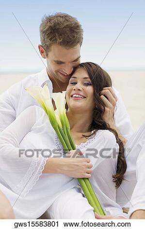 Stock Image - Close-up of a young couple on the beach. Fotosearch