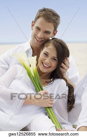 Close-up of a young couple smiling on the beach View Large Photo Image Stock Photography - Close-up of a young couple smiling on the beach. Fotosearch