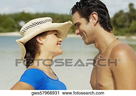 Close-up of a young man and a teenage girl looking at each other View Large Photo Image Stock Image - Close-up of a young man and a teenage girl looking at each other. Fotosearch