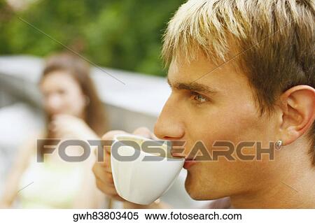 Close-up of a young man having a cup of tea View Large Photo Image Stock Photography - Close-up of a young man having a cup of tea. Fotosearch