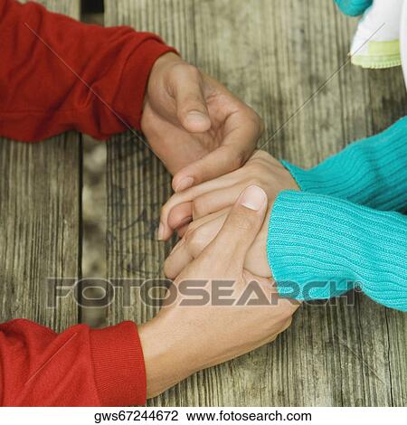 Close-up of a young man holding a young woman's hands View Large Photo Image Stock Image - Close-up of a young man holding a young woman's hands. Fotosearch