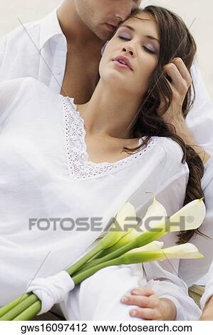 Close-up of a young man kissing a young woman View Large Photo Image Stock Image - Close-up of a young man kissing a young woman. Fotosearch
