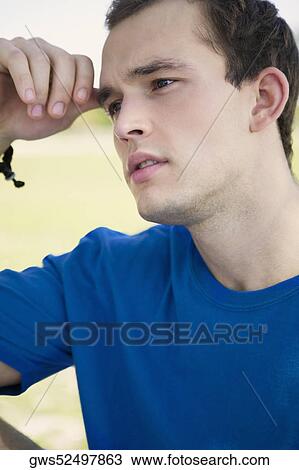 Close-up of a young man looking serious View Large Photo Image Stock Image - Close-up of a young man looking serious. Fotosearch