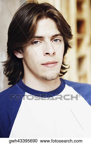 Close-up of a young man smirking View Large Photo Image Stock Image - Close-up of a young man smirking. Fotosearch