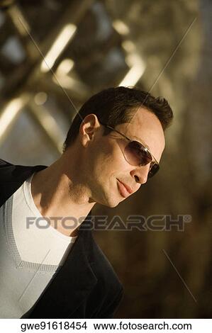 Picture - Close-up of a young man wearing sunglasses. Fotosearch
