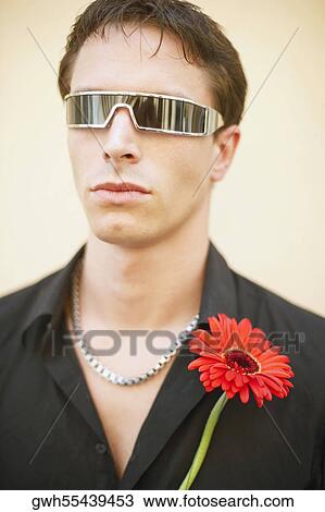 Close-up of a young man wearing sunglasses View Large Photo Image Stock Image - Close-up of a young man wearing sunglasses. Fotosearch