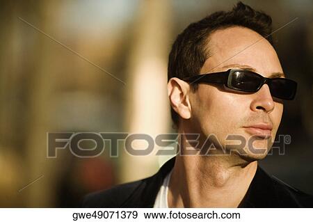 Stock Photo - Close-up of a young man wearing sunglasses. Fotosearch