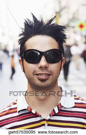Close-up of a young man wearing sunglasses View Large Photo Image Stock Photography - Close-up of a young man wearing sunglasses . Fotosearch