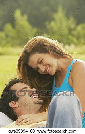Close-up of a young woman and a mature man smiling View Large Photo Image Stock Image - Close-up of a young woman and a mature man smiling. Fotosearch
