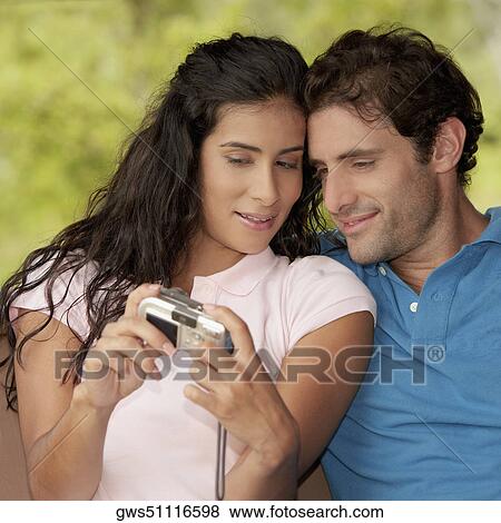 Close-up of a young woman and a mid adult man photographing themselves View Large Photo Image Stock Photo - Close-up of a young woman and a mid adult man photographing themselves. Fotosearch