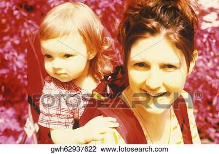 Close-up of a young woman and her daughter View Large Photo Image Stock Image - Close-up of a young woman and her daughter. Fotosearch