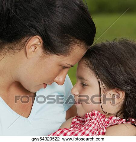 Close-up of a young woman and her daughter View Large Photo Image Stock Image - Close-up of a young woman and her daughter. Fotosearch