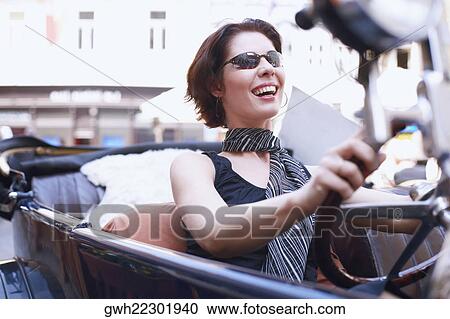Close-up of a young woman driving a car View Large Photo Image Stock Image - Close-up of a young woman driving a car . Fotosearch