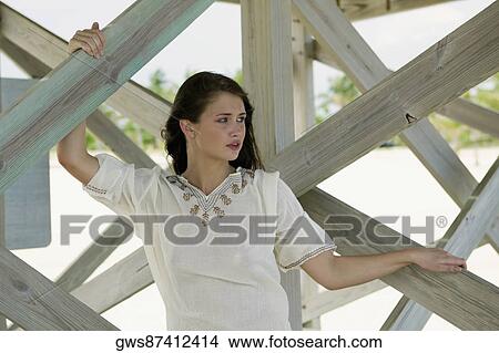 Picture - Close-up of a young woman holding a wooden plank. Fotosearch