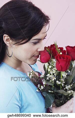 Close-up of a young woman holding a bunch of roses View Large Photo Image Stock Image - Close-up of a young woman holding a bunch of roses. Fotosearch