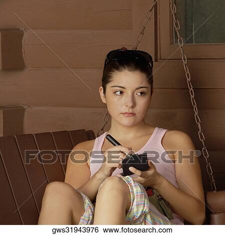 Stock Photograph - Close-up of a young woman holding a make-up brush. Fotosearch