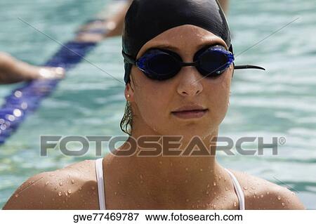 Stock Photo - Close-up of a young woman in a swimming pool. Fotosearch