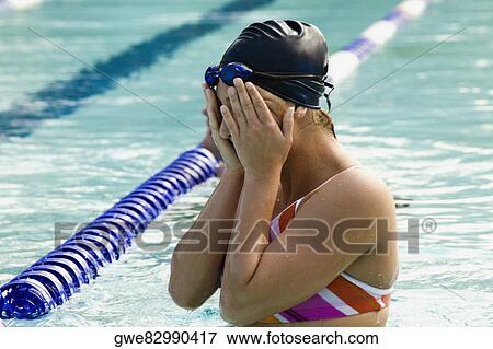 Close-up of a young woman in a swimming pool View Large Photo Image Stock Photo - Close-up of a young woman in a swimming pool. Fotosearch