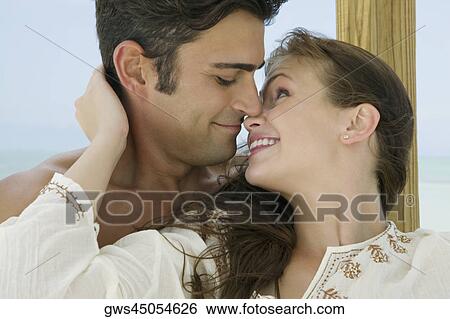 Close-up of a young woman kissing a young man View Large Photo Image Stock Photograph - Close-up of a young woman kissing a young man. Fotosearch