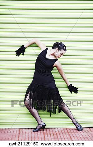 Close-up of a young woman leaning against a shutter View Large Photo Image Stock Image - Close-up of a young woman leaning against a shutter. Fotosearch