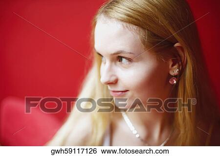 Close-up of a young woman looking sideways View Large Photo Image Stock Photograph - Close-up of a young woman looking sideways . Fotosearch