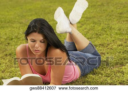 Stock Photo - Close-up of a young woman reading a book. Fotosearch