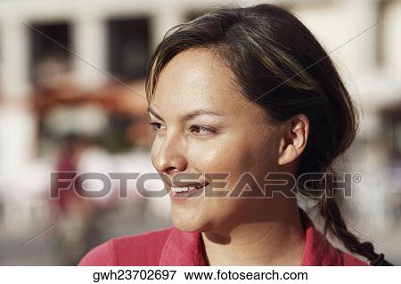 Close-up of a young woman smiling View Large Photo Image Stock Photo - Close-up of a young woman smiling . Fotosearch