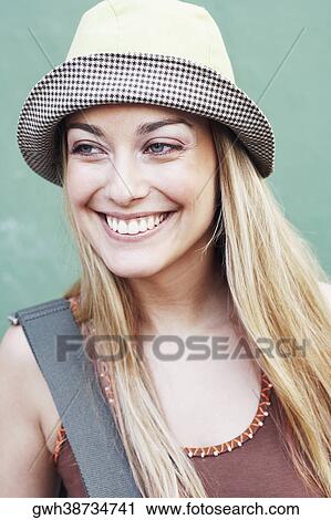 Stock Image - Close-up of a young woman wearing a hat. Fotosearch