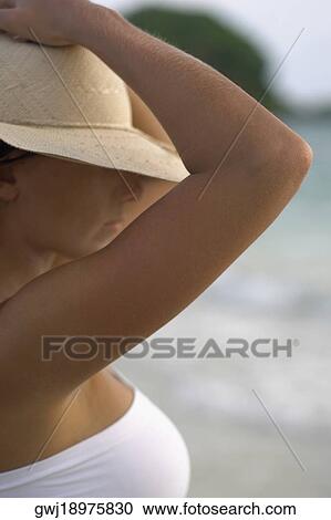 Close-up of a young woman wearing a sun hat View Large Photo Image Stock Image - Close-up of a young woman wearing a sun hat. Fotosearch