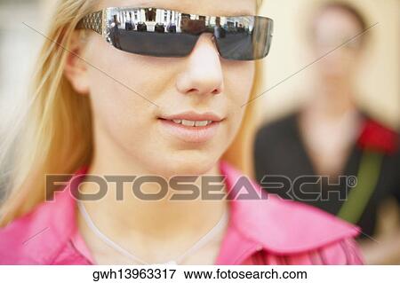 Stock Photo - Close-up of a young woman wearing sunglasses. Fotosearch