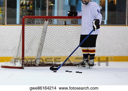 Close Up Of An Ice Hockey Player Standing In Front Of A Goal Post Picture Gwe Fotosearch