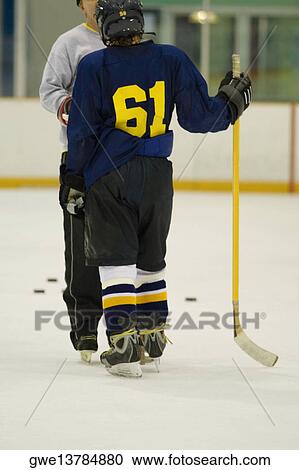 Close-up of an ice hockey player standing face to face with another player View Large Photo Image Stock Image - Close-up of an ice hockey player standing face to face with another player. Fotosearch