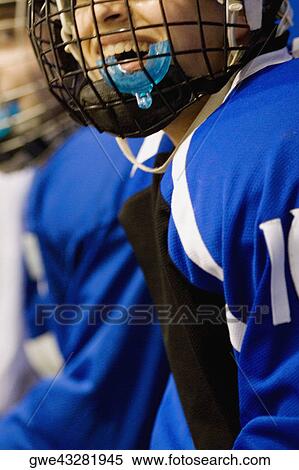 Close-up of an ice hockey player wearing a helmet and smiling View Large Photo Image Stock Photography - Close-up of an ice hockey player wearing a helmet and smiling. Fotosearch