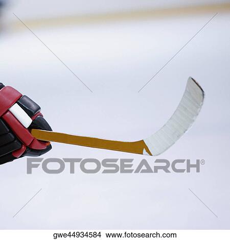 Picture - Close-up of an ice hockey player's hand holding an ice hockey stick. Fotosearch