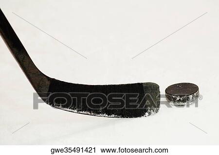 Close-up of an ice hockey stick with a hockey puck View Large Photo Image Stock Image - Close-up of an ice hockey stick with a hockey puck. Fotosearch