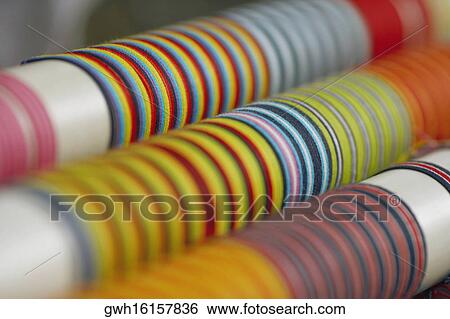 Stock Photograph - Close-up of colored laces on poles. Fotosearch