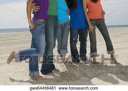 Close-up of five people standing on the beach View Large Photo Image Stock Image - Close-up of five people standing on the beach. Fotosearch