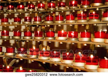 Stock Image - Close-up of lit candles. Fotosearch