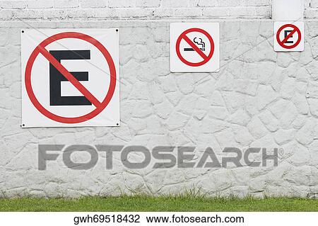 Close-up of no eating sign with no smoking sign on a wall View Large Photo Image Stock Image - Close-up of no eating sign with no smoking sign on a wall. Fotosearch