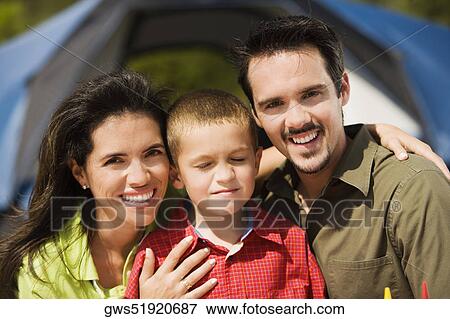 Close-up of parents smiling with their son View Large Photo Image Stock Photo - Close-up of parents smiling with their son. Fotosearch