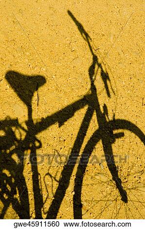Close-up of the shadow of a bicycle View Large Photo Image Stock Image - Close-up of the shadow of a bicycle. Fotosearch