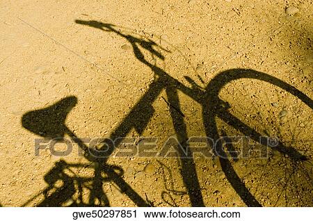 Close-up of the shadow of a bicycle View Large Photo Image Stock Image - Close-up of the shadow of a bicycle. Fotosearch
