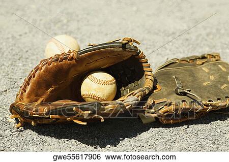 Stock Photograph - Close-up of two baseball gloves and two baseballs. Fotosearch